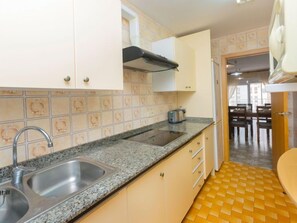 Fridge, microwave, cookware/dishes/utensils, dining tables