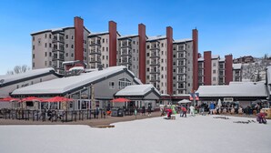 A hotel with multiple floors, balconies, and a snow-covered roof. - Ski-in/Out, Walk to Base Area - Torian Plum - Pool& Hot Tubs (Steamboat Springs)