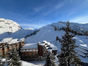 A snow-covered mountain resort with a ski lift, wooden buildings, and snow-covered trees. - Avoriaz: Sunny duplex, 2 bedrooms, sleeps 7 (Avoriaz)