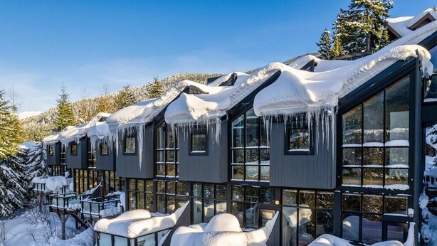 A row of cabins with large windows and snow-covered roofs. - 3BR Townhouse • AC • Fireplace • Lake & Trail Views • 6-Min to Gondola (Whistler)