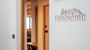 A hallway with a door labeled 'Panorama' and a mountain illustration.