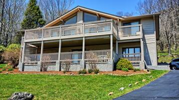 A two-story house with a balcony on the upper floor and a covered porch on the ground floor.