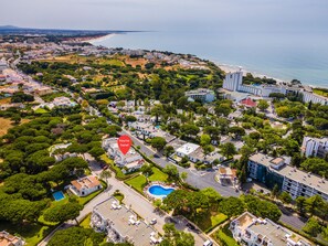An aerial view of a coastal residential area with a prominent red marker indicating a specific location. - Albufeira Family Holidays at Balaia 143 (Albufeira)
