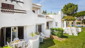 A white villa with a pool, outdoor seating, and a well-maintained lawn. - Albufeira Family Holidays at Balaia 143 (Albufeira)