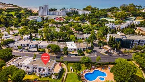 An aerial view of a coastal residential area with a swimming pool, multiple buildings, and a beach in the background. - Albufeira Family Holidays at Balaia 143 (Albufeira)