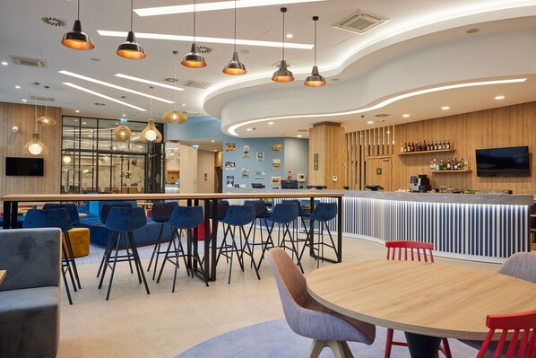 Relax and socialize in our inviting bar area with a curved counter and comfortable seating options.