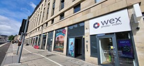 A building with a 'Wex Photo | Video' sign, indicating a photo and video service. - JOIVY Affordable Edinburgh - Adults only (Edinburgh)