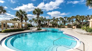 A swimming pool with a 3½ ft depth, surrounded by palm trees and a covered area. - Book 3 Nights & Get 1 Free/See Description*6 Seat Golf Cart*Pool*Tiki Bar*HotTub (Miramar Beach)