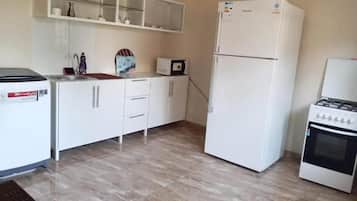 Apartment | Private kitchen | Fridge, microwave, cookware/dishes/utensils, dining tables