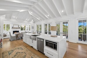 A spacious kitchen with white cabinetry, a built-in dishwasher, and a large island with a microwave. - EXQUISITE LUXURY HOME w/ POOL, LSV, BIKES! NEXT TO CAMP WATERCOLOR! Pet Friendly! (Santa Rosa Beach)