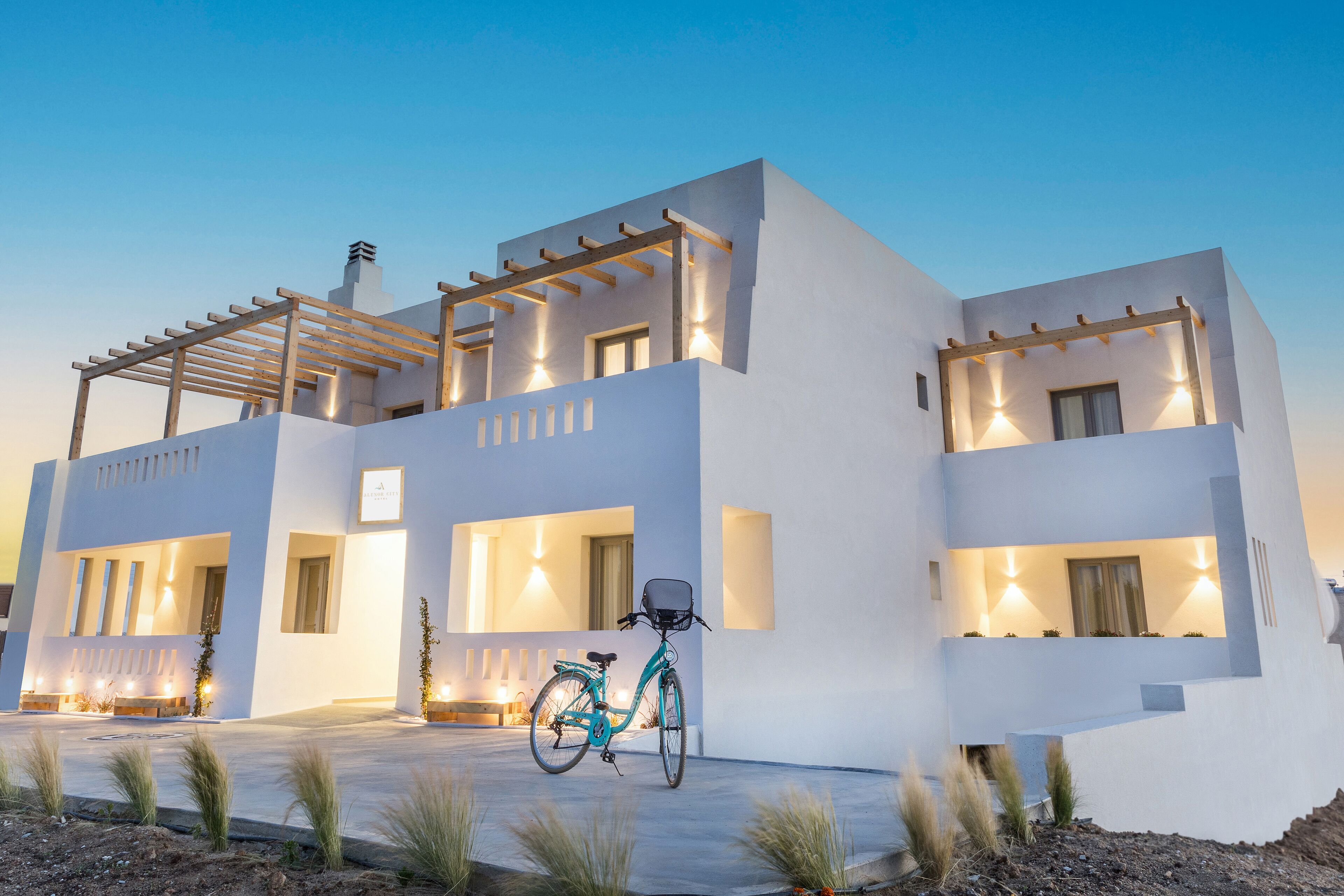 A modern two-story house with a bicycle parked in front.