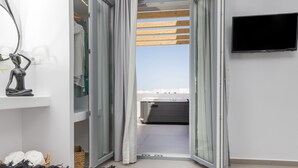 A modern room with a bed, a TV, and a view of the sky through an open door. - Alenor City Hotel (Naxos)