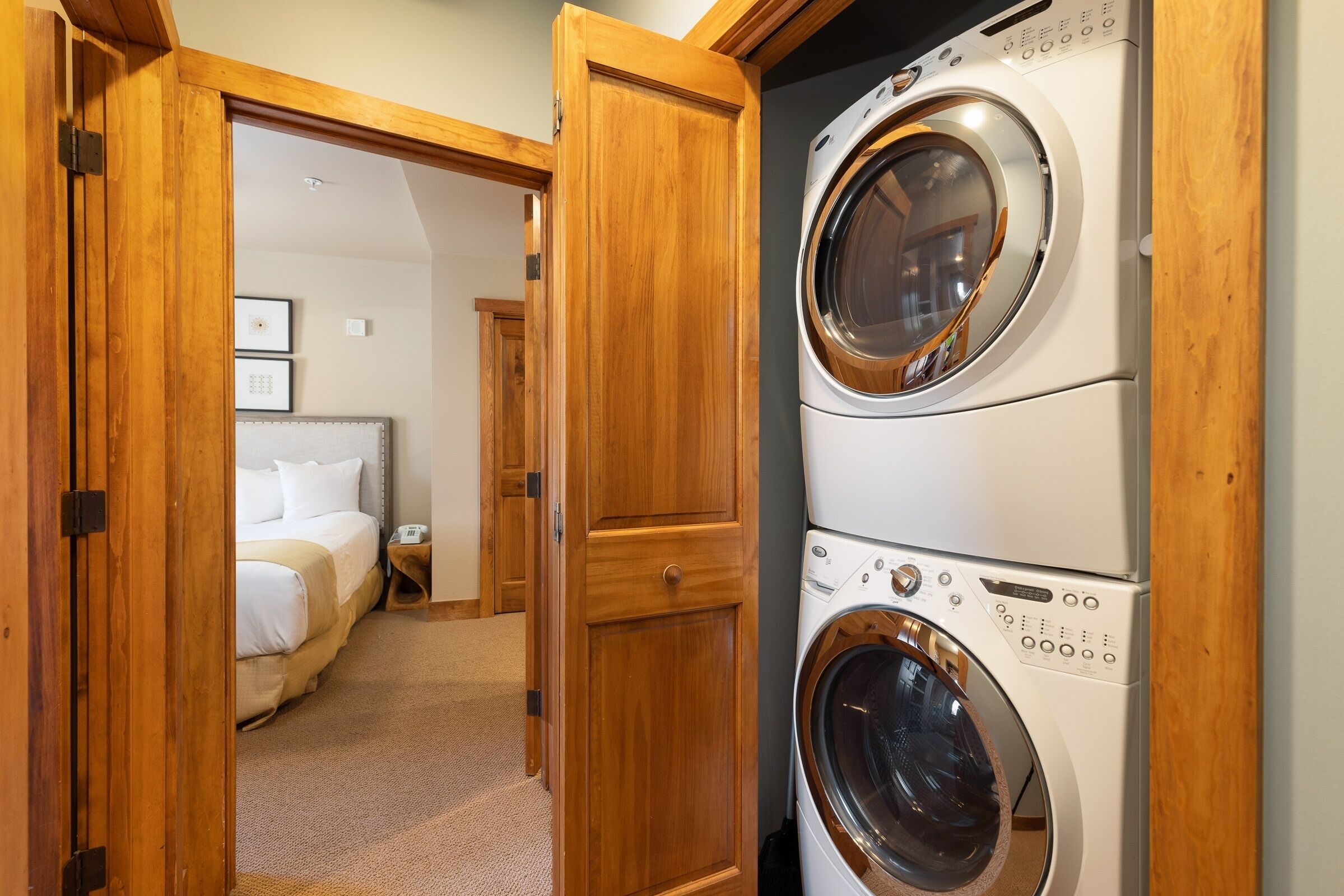 A laundry room with two stacked front-loading washing machines.