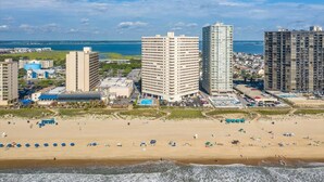 A coastal cityscape with high-rise buildings, a beach, and a marina. - Gorgeous 2 BR/ 2 BA Beachfront Condo (Ocean City)