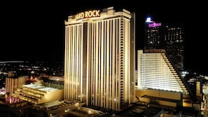 Experience the iconic architecture of the Hard Rock Hotel & Casino, standing out against the night sky.