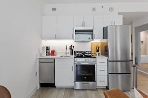 Enjoy cooking in this well-equipped kitchen with a microwave, stove, oven, and refrigerator.