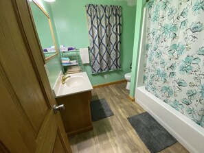 Combined shower/tub, hair dryer, towels, soap