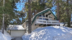 A two-story building with a balcony, surrounded by trees and covered in snow. - 3 bedroom dream home 🏡 Big Bear Lake CA / Running Springs/Lake Arrowhead. (Running Springs)