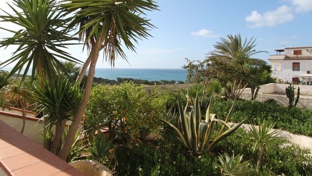 A garden with various plants and a view of the sea. - Il Canneto Vecchia Marina (castelvetrano)