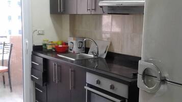 Fridge, electric kettle, cookware/dishes/utensils