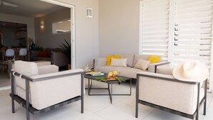 A modern living room with a sofa, two armchairs, and a coffee table. - Villa Orlov - Luxury villa on the water (Le Diamant)