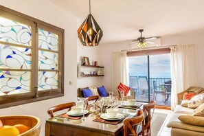 Enjoy meals in this inviting dining area with a large window offering a view of the outdoors.