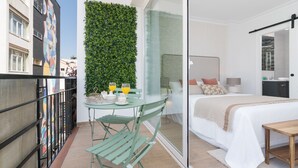 A modern hotel room with a balcony, a green wall, and a bed with a white bedspread.