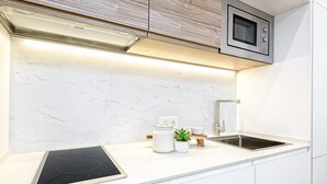 A modern kitchen with a built-in stove, a microwave, and a sink. - iloftmalaga Madre de Dios V - 2B (Málaga)