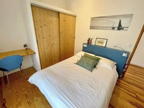 A bedroom with a bed, a desk, and a wardrobe. - Architect villa in nature near ocean & bay A0389 (Lège-Cap-Ferret)