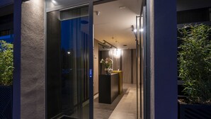 A modern hotel entrance with a glass door and a sign reading "VELVET rooms & more". - Velvet rooms & more (Zadar)