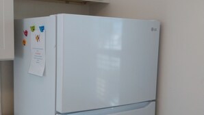 A white refrigerator with a note attached to it. - Studio #1 Fully-equipped with Boardwalk Patio Access - Oceanfront! Pet-Friendly! (San Diego)