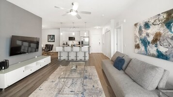 Deluxe Condo, 2 Bedrooms | Living area | 50-inch TV with digital channels