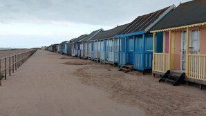 Eine Reihe von Strandhäusern mit einem Sandweg zum Strand.