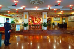 A hotel lobby with a polished floor, red lanterns, and a large decorative entrance. - Fuchun Hotel (Fu'an)