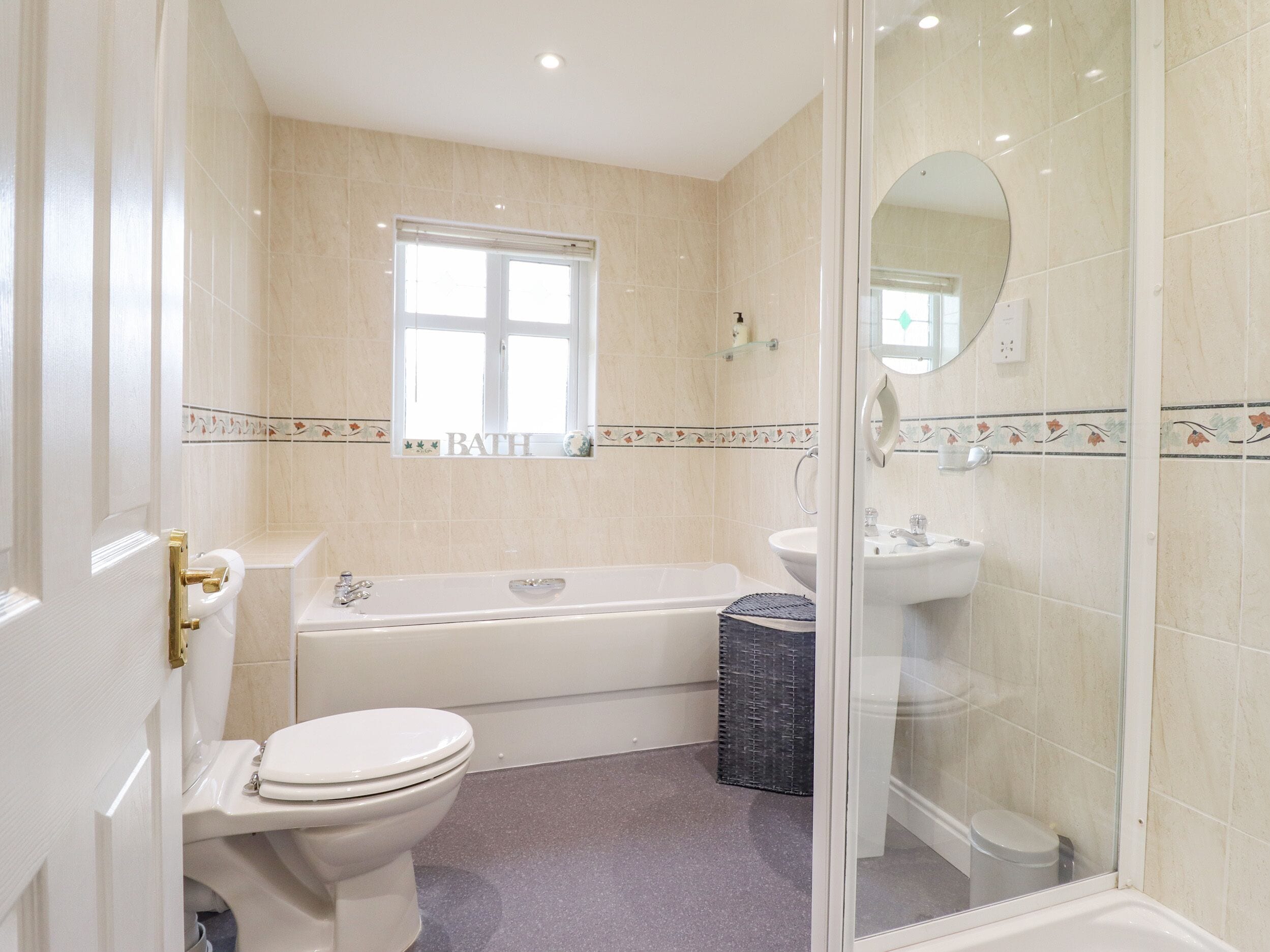 A bathroom with a toilet, bathtub, and sink.