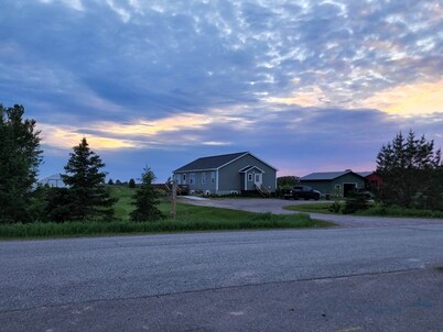 Country, close to town, sled trails, skiing, large snowmobile boat trailer space