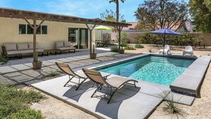 A backyard with a swimming pool, outdoor seating, and a pergola. - Tangerine Desert Dreams - A Ryson Property (Palm Springs)