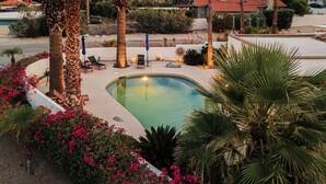 A pool area with lounge chairs, palm trees, and a mountain backdrop. - Casa Coyote - A Ryson Property (Palm Springs)