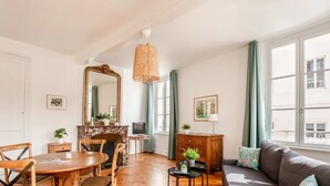 Una sala de estar acogedora con una mesa redonda de madera, un sofá y una chimenea.