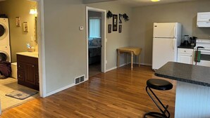 A compact apartment with a kitchen, dining area, and a small living space. - Wonderful two-bedroom home with a full kitchen (Pierre)