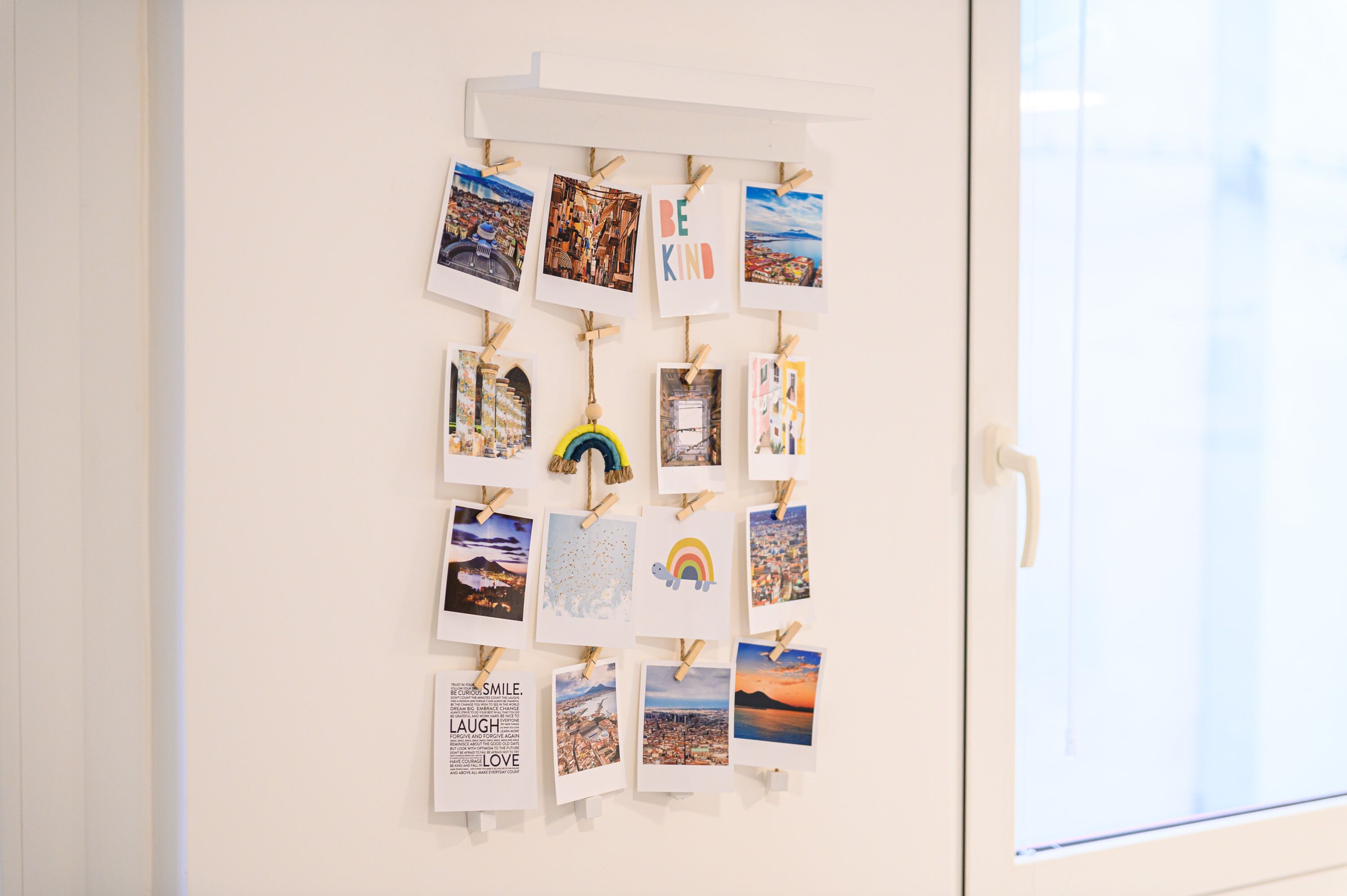 A wall with various photographs and inspirational quotes.