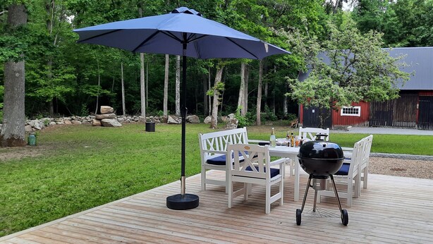 An outdoor patio with a grill, chairs, and a table. - Swedish idyll - dreamlike secluded location - close to the lake - sauna - pool table (Nybro)