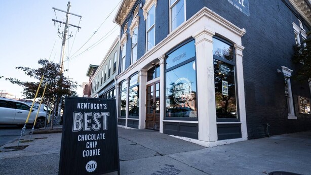 A storefront with a sign stating "Kentucky's Best Chocolate Chip Cookie."