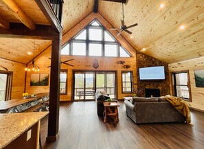 Relax in this spacious room with a seating area, fireplace, and large windows.