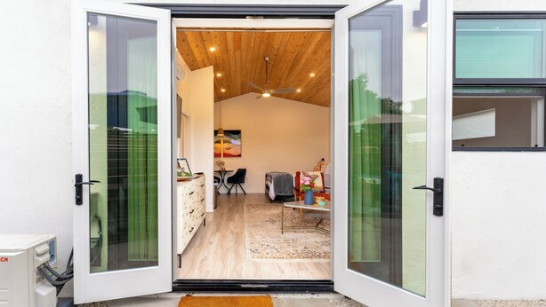 A modern interior with a wooden ceiling, a dining area, and a kitchen visible through glass doors. - Close to downtown, with a llama, alpaca, and others animlas on the property (Thousand Oaks)