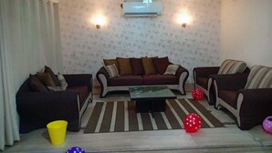 A living room with a sofa set, a coffee table, and decorative balls.