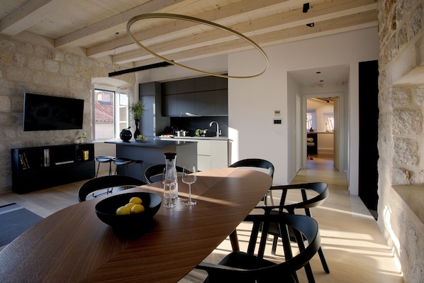 Enjoy meals in the dining area with a wooden table and comfortable seating.