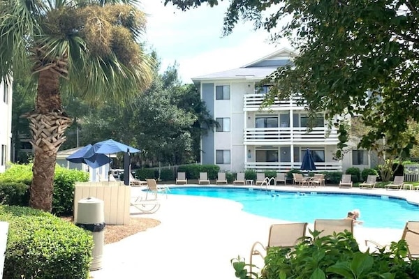 Take a dip in the large community swimming pool, surrounded by lounge chairs.