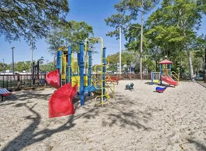 A playground with various play structures including slides and climbing frames.