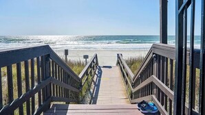 A wooden boardwalk leading to a beach with a clear view of the ocean. - NEW! Ocean-Front Resort, Steps From Beach, 6 pools and Lazy River (Myrtle Beach)